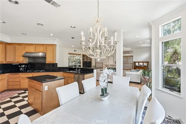 a kitchen with stainless steel appliances kitchen island granite countertop a sink and a granite counter tops
