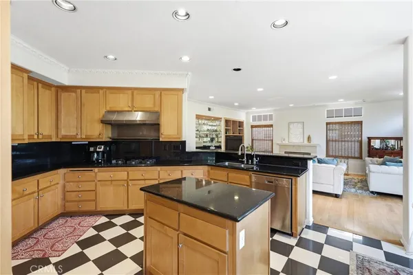 a kitchen with a sink a stove and cabinets