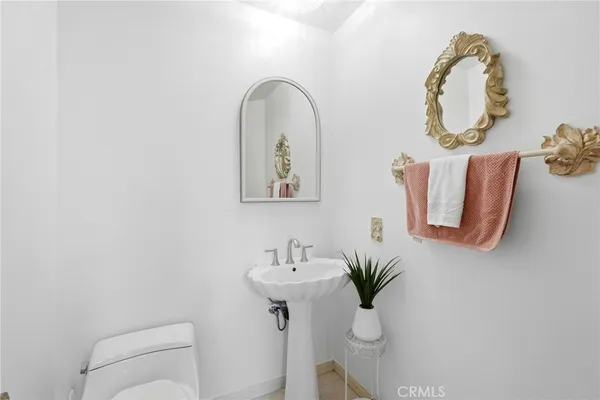 a bathroom with a sink mirror and toilet