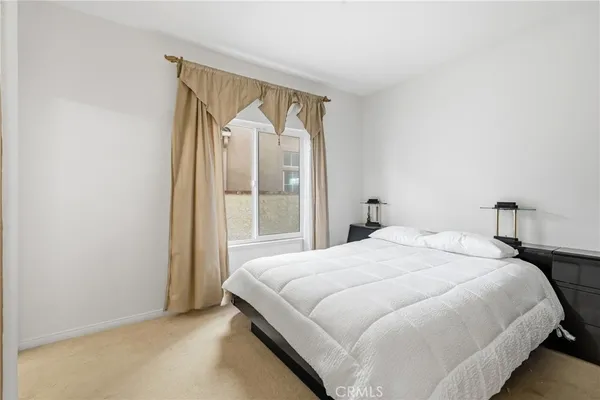 a bedroom with a bed and a mirror