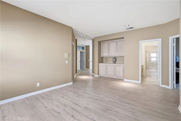 a view of a kitchen with wooden floor and refrigerator