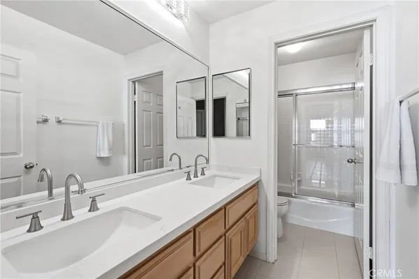 a bathroom with a double vanity sink mirror and double