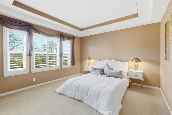 a bedroom with bed and a large window