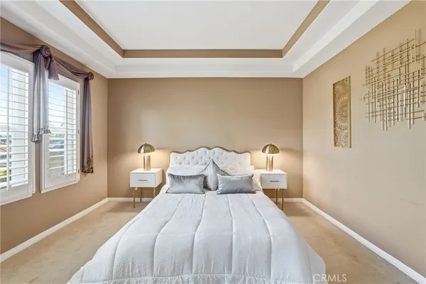 a bed room with a bed and a large window