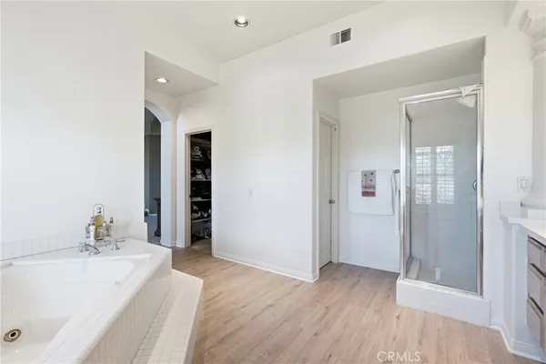 a spacious bathroom with a tub and shower
