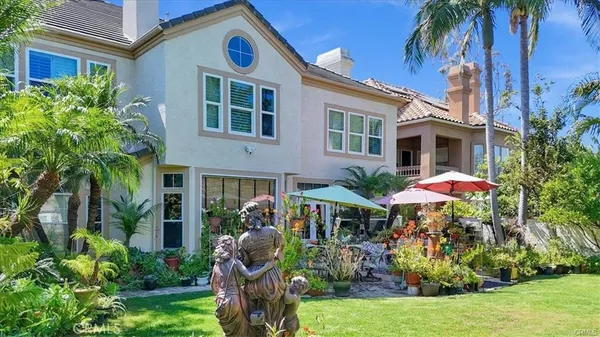 a front view of a house with yard and sitting area