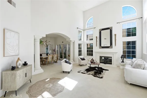 a living room with furniture fireplace and a large window