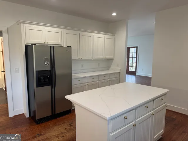 a kitchen with a refrigerator and a sink