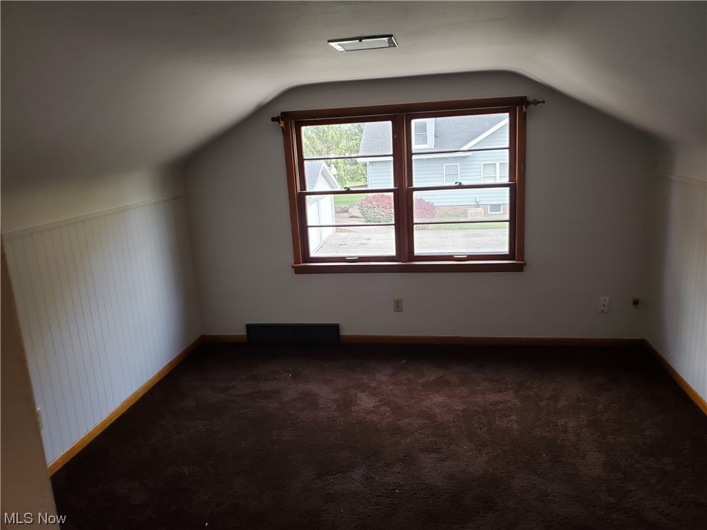 5530 Manchester Road Akron, OH 44319 - Photo 16 of 24 Bonus room featuring lofted ceiling and dark carpet