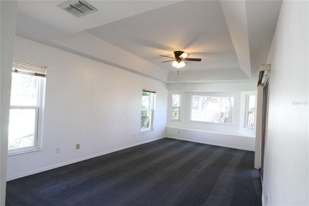 1414 Norwick Drive Lutz, FL 33559 - Photo 12 of 43 an empty room with wooden floor and windows