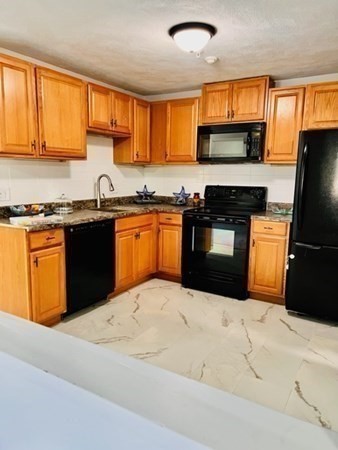 15 Spencer Road, Unit 26E Boxborough, MA 01719 - Photo 17 of 27 a kitchen with stainless steel appliances granite countertop a stove a sink dishwasher a refrigerator and a microwave oven
