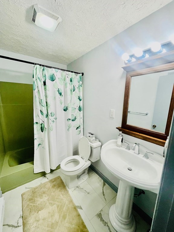 15 Spencer Road, Unit 26E Boxborough, MA 01719 - Photo 27 of 27 a bathroom with a sink toilet and shower