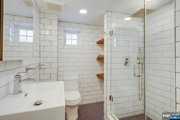 a bathroom with a shower a toilet and sink