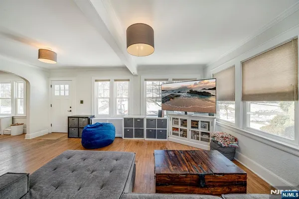a living room with furniture fireplace and a large window