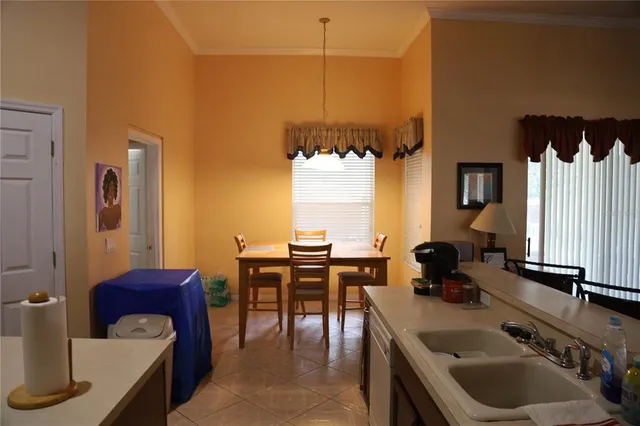 a kitchen with a table chairs and a sink