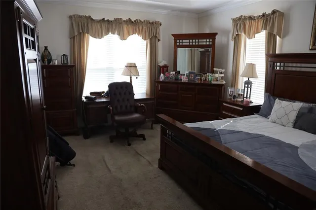 a room with a bed furniture and a window