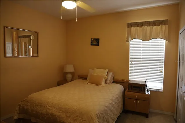 a bedroom with a bed and a lamp