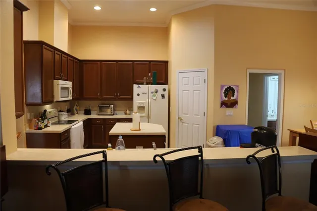 a kitchen with stainless steel appliances a refrigerator and a stove top oven