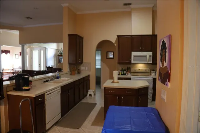 a kitchen with stainless steel appliances a sink stove and refrigerator