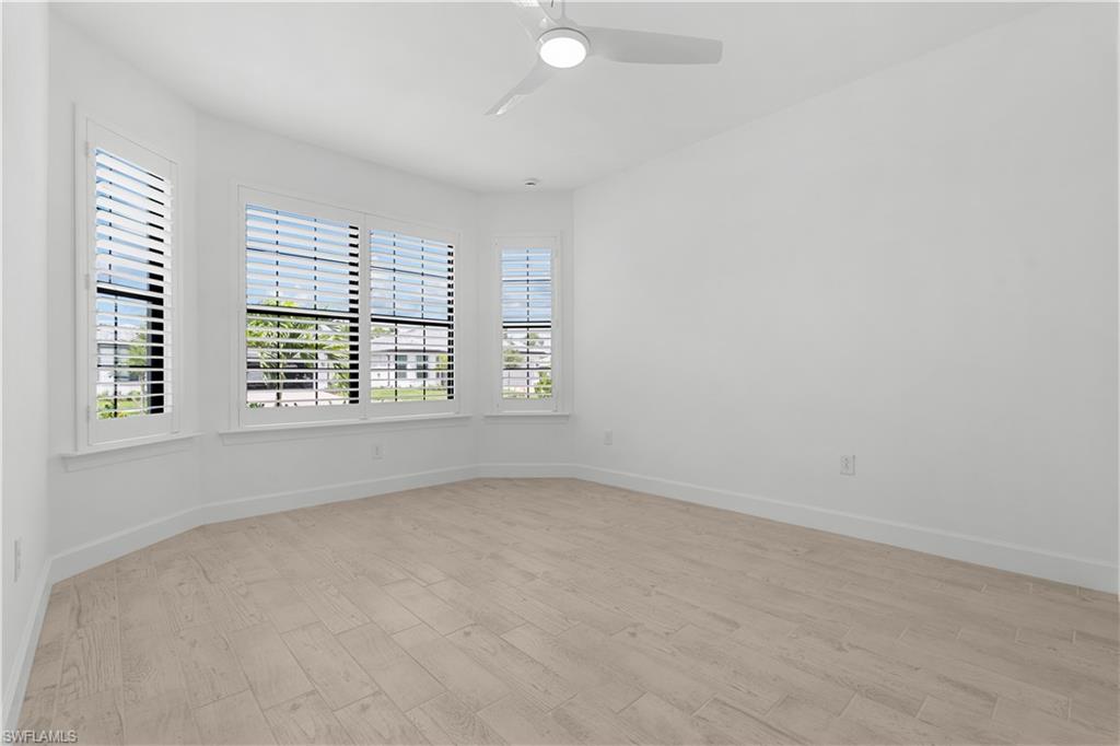 2104 Freemont Way Naples, FL 34119 - Photo 12 of 27 Front bedroom with lots of natural lighting