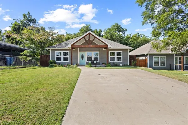 a front view of house with yard and green space