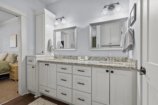 a bathroom with a granite countertop sink and a mirror