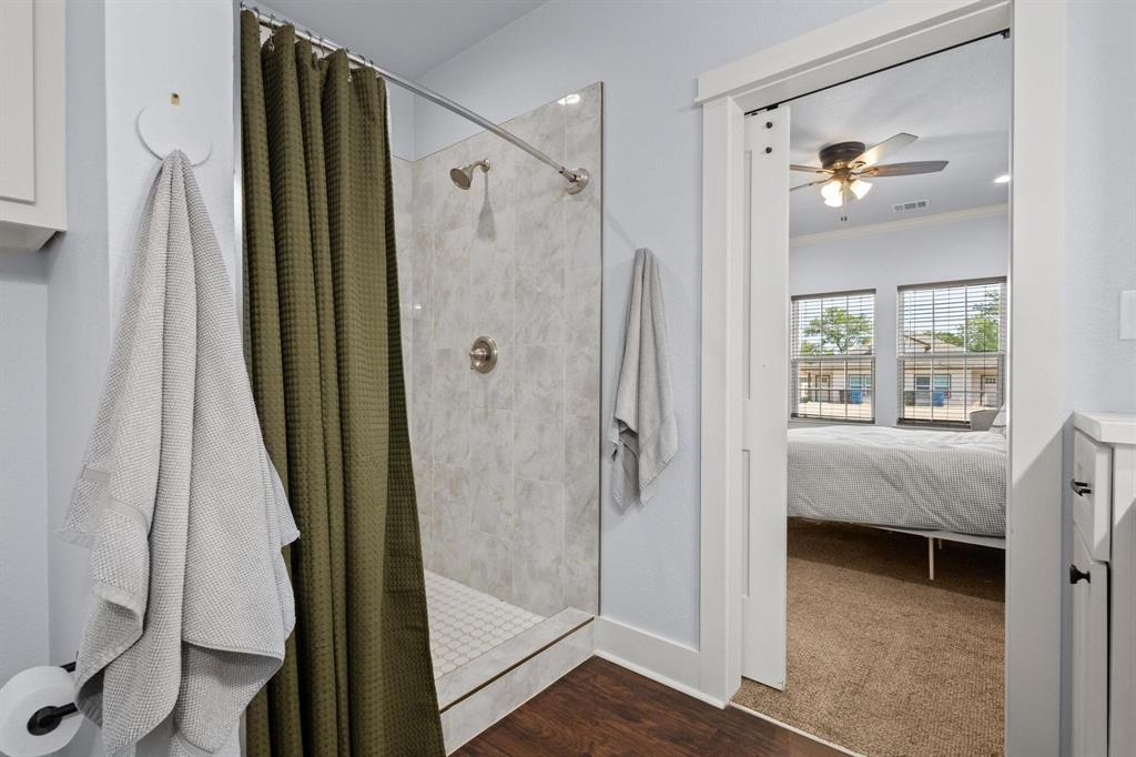 610 West Elm Street Denison, TX 75020 - Photo 15 of 26 a bathroom with a shower and a tub
