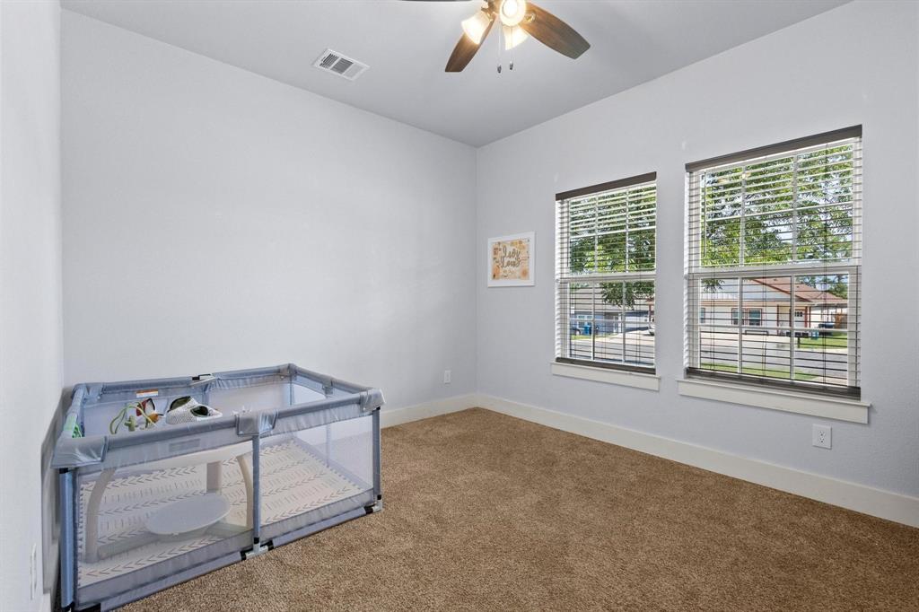 610 West Elm Street Denison, TX 75020 - Photo 19 of 26 an empty room with windows