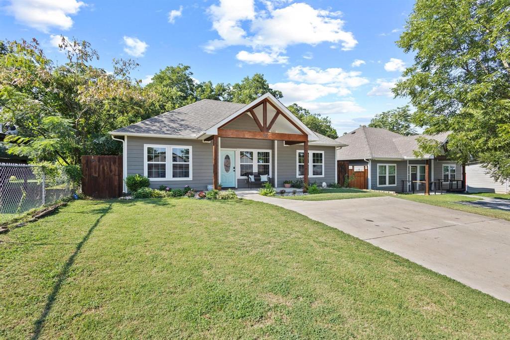 610 West Elm Street Denison, TX 75020 - Photo 2 of 26 a front view of a house with a garden
