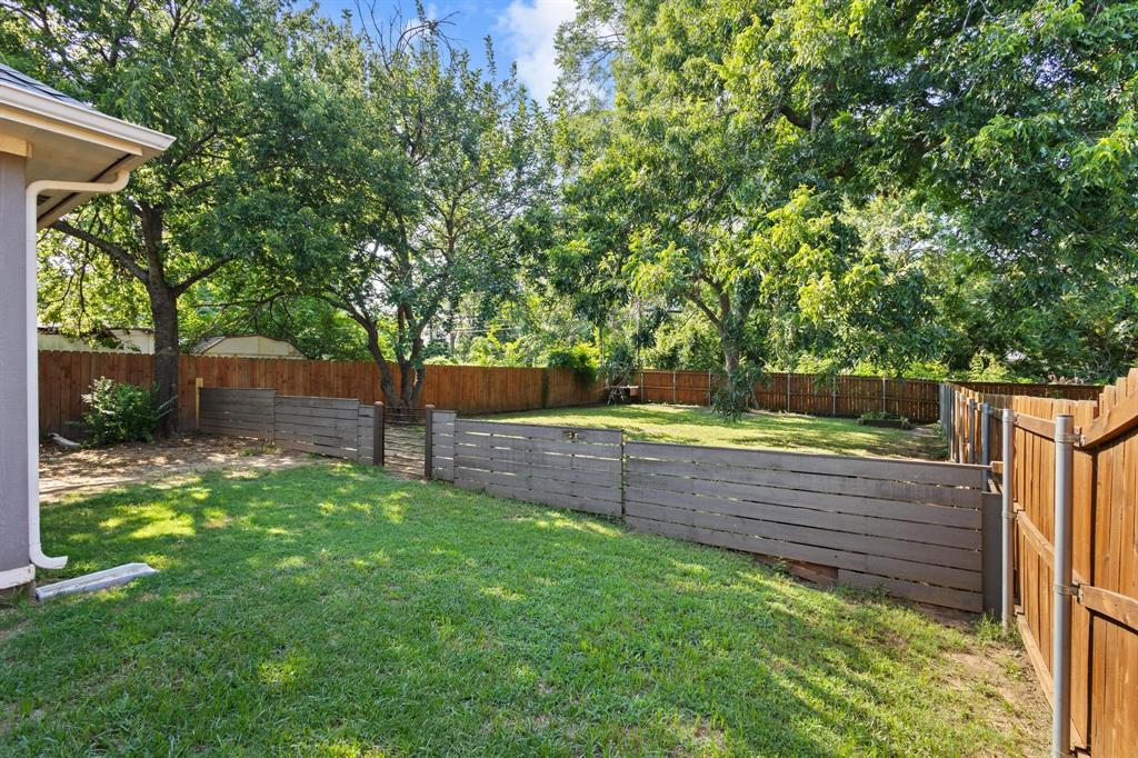 610 West Elm Street Denison, TX 75020 - Photo 23 of 26 a view of a backyard with wooden fence