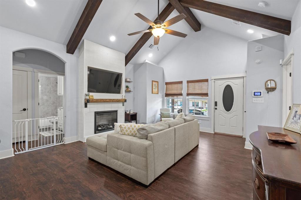 610 West Elm Street Denison, TX 75020 - Photo 6 of 26 a living room with furniture a fireplace and a flat screen tv