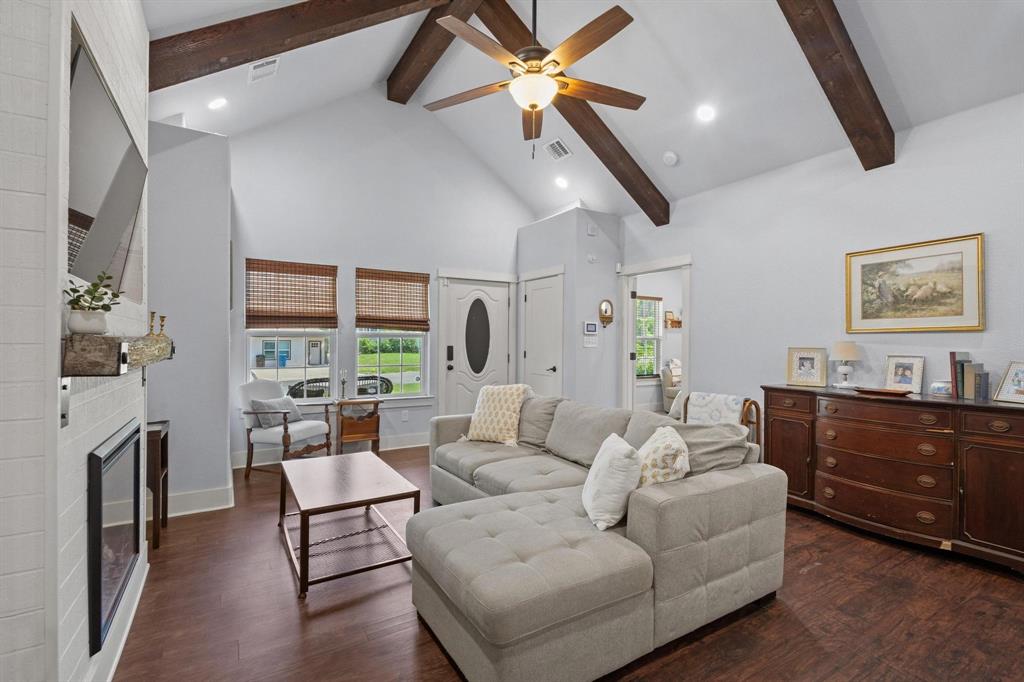610 West Elm Street Denison, TX 75020 - Photo 7 of 26 a living room with furniture a fireplace and a chandelier