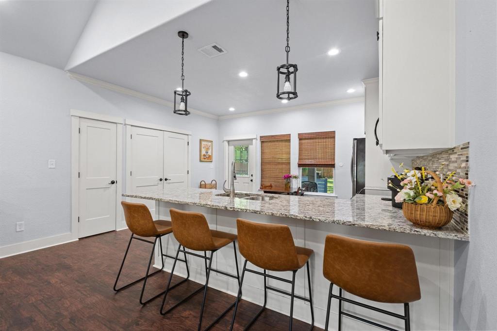 610 West Elm Street Denison, TX 75020 - Photo 9 of 26 a view of a dining room with furniture and a chandelier