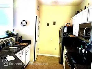 a kitchen with a refrigerator and a stove