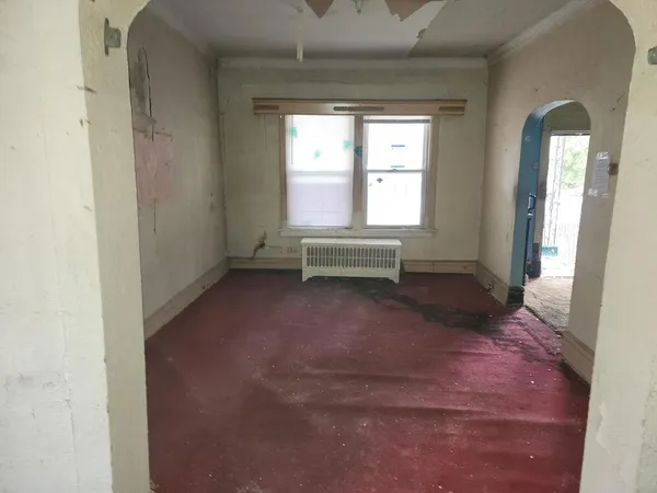 a view of a livingroom with wooden floor and a window
