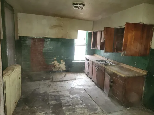 a bathroom with a granite countertop sink a toilet and shower