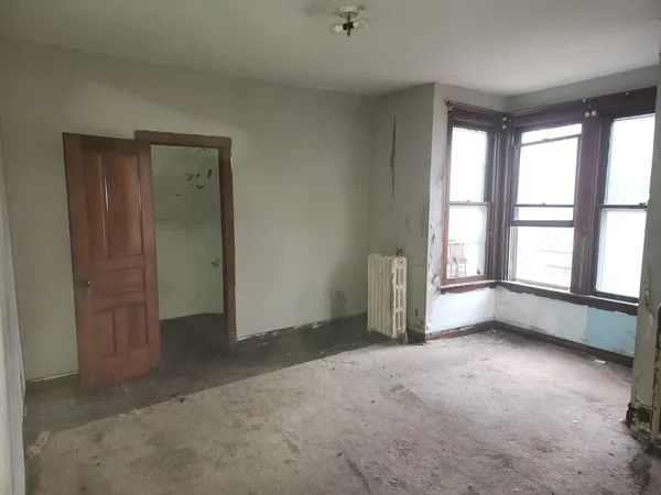 an empty room with windows and closet