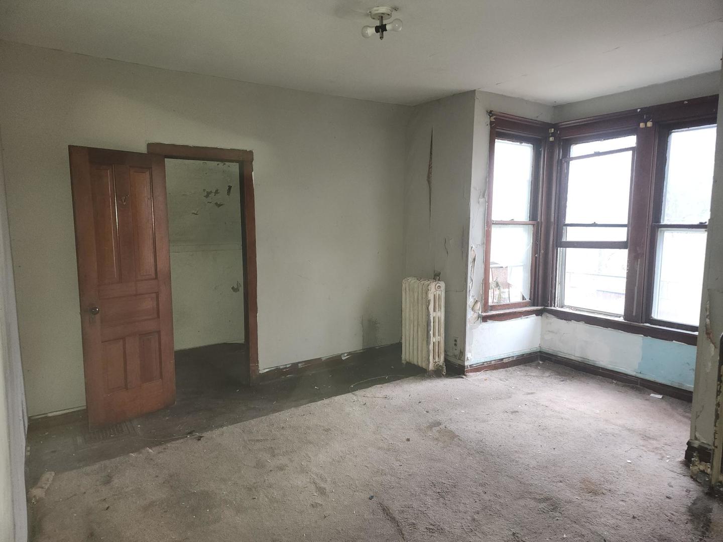 5633 South Sangamon Street Chicago, IL 60621 - Photo 7 of 11 an empty room with windows and closet