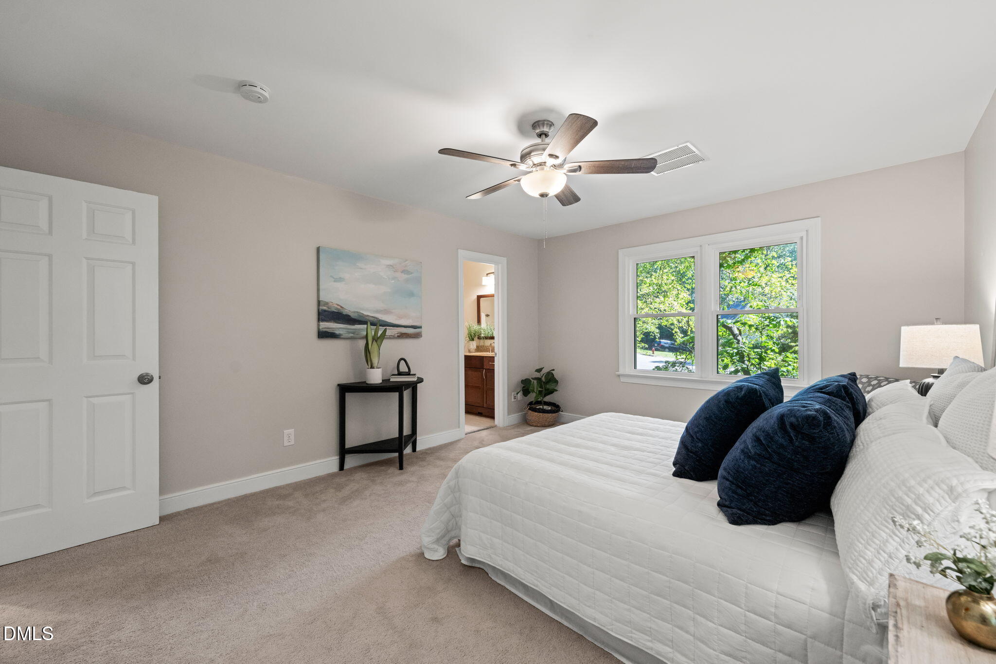 18 Strawberry Ridge Lane Durham, NC 27713 - Photo 27 of 59 a bedroom with a large bed and a chandelier