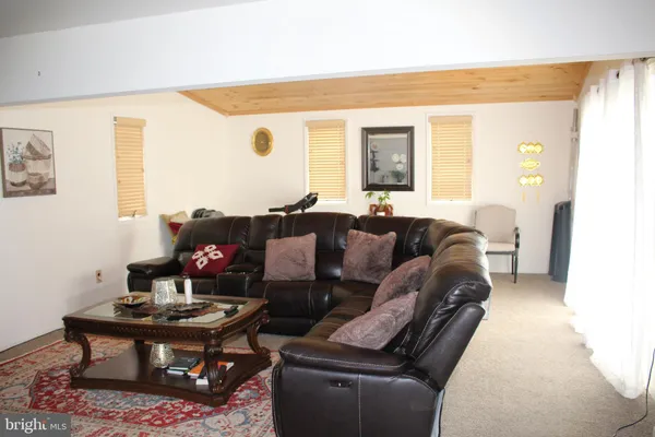 a bedroom with furniture and a flat screen tv