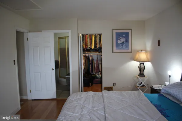 a view of a hallway with wooden floor and a livingroom