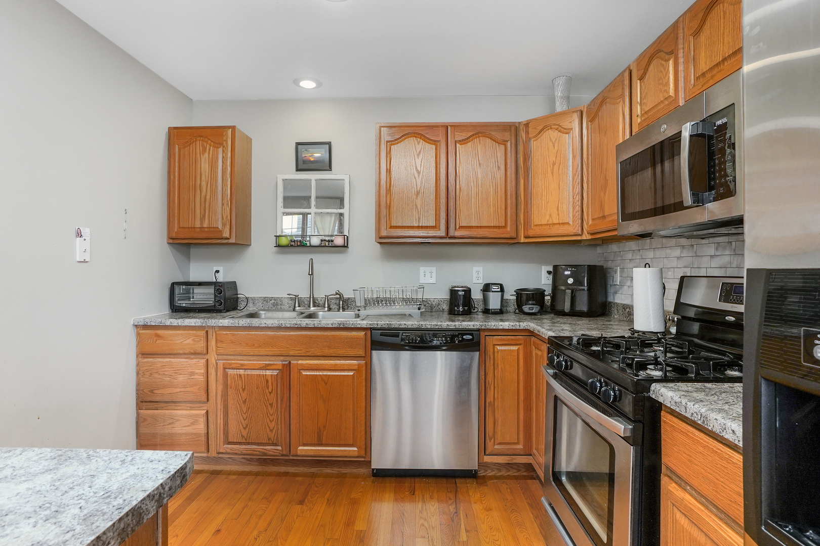 586 South Peace Road, Unit 586 Sycamore, IL 60178 - Photo 8 of 19 a kitchen with stainless steel appliances granite countertop a stove a sink and a microwave