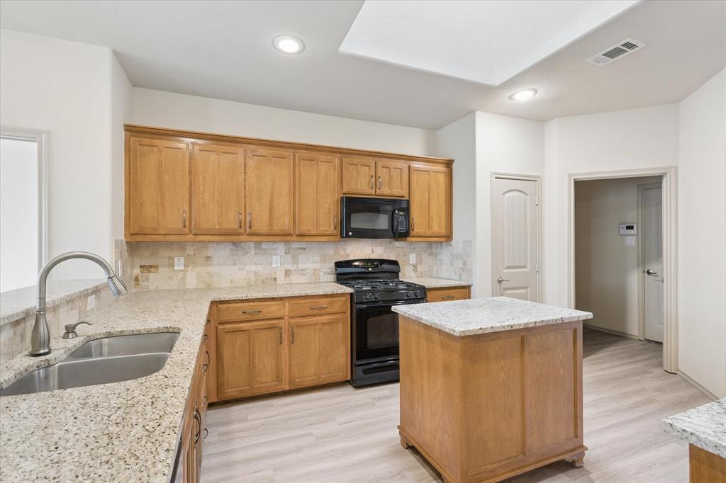 10205 Point Lobos Trail Fort Worth, TX 76177 - Photo 11 of 29 a kitchen with stainless steel appliances granite countertop a sink stove and refrigerator