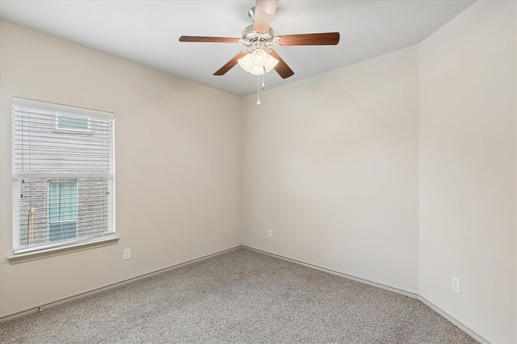 10205 Point Lobos Trail Fort Worth, TX 76177 - Photo 16 of 29 an empty room with a window and a ceiling fan