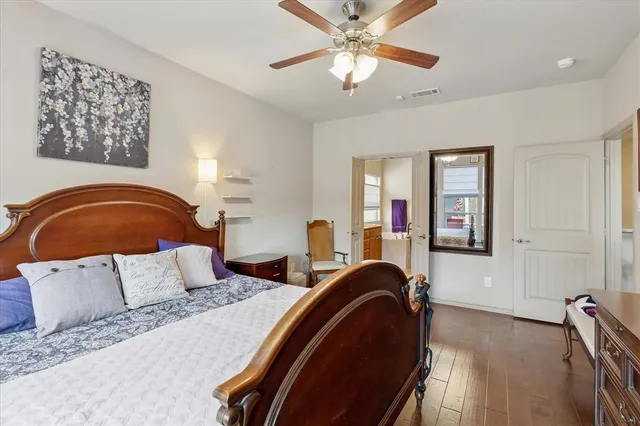 a bedroom with a large bed and a chandelier