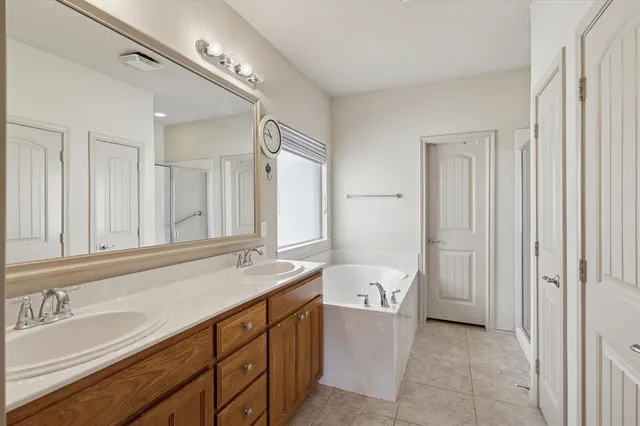 a bathroom with a sink a toilet and a large mirror