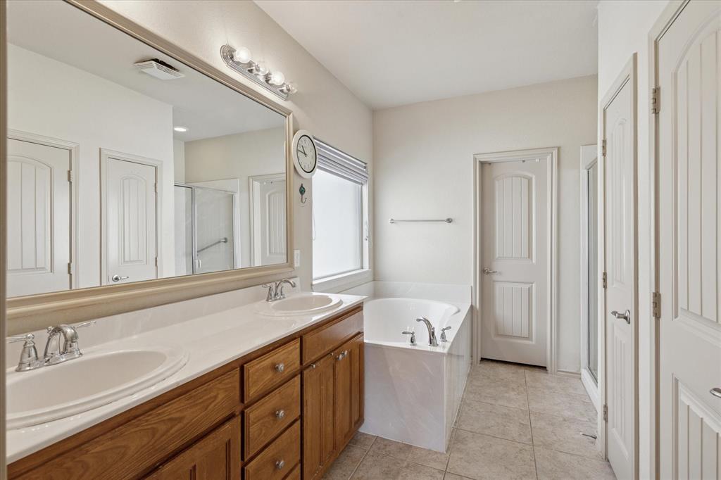 10205 Point Lobos Trail Fort Worth, TX 76177 - Photo 20 of 29 a bathroom with a sink a toilet and a large mirror