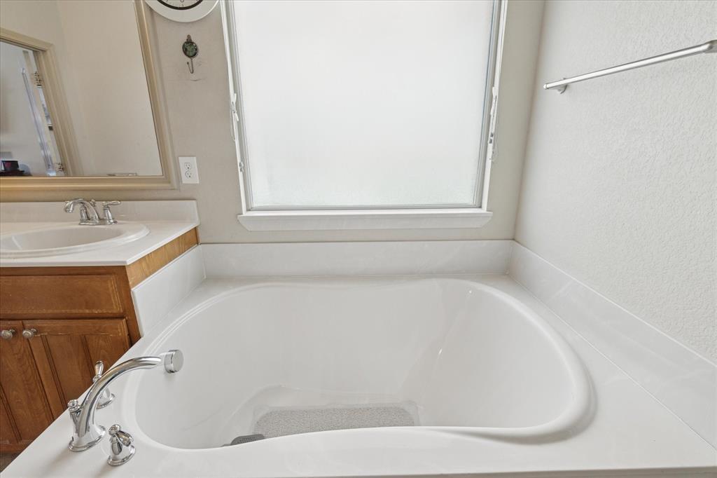 10205 Point Lobos Trail Fort Worth, TX 76177 - Photo 22 of 29 a white bath tub sitting in a bathroom