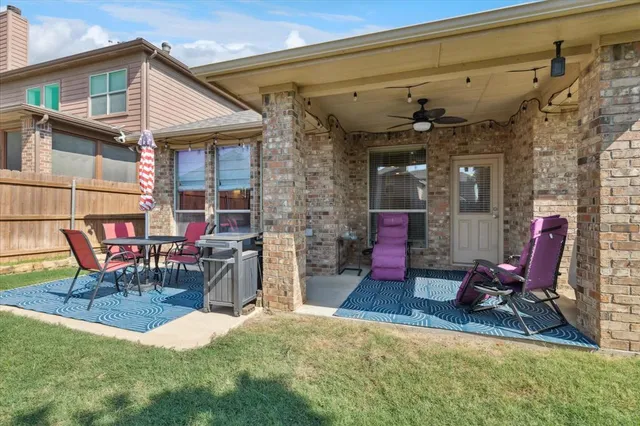 a view of a chairs and tables in the back yard of the house