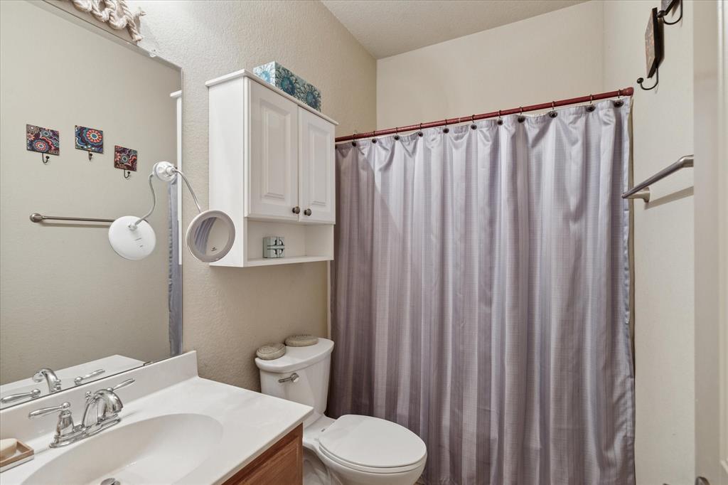 10205 Point Lobos Trail Fort Worth, TX 76177 - Photo 25 of 29 a bathroom with a sink a toilet and shower curtain